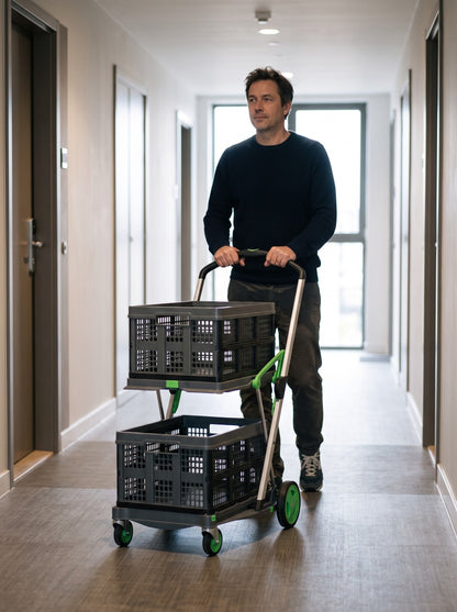 Pushing the EasyRoll trolley through an apartment corridor, handle in the high position