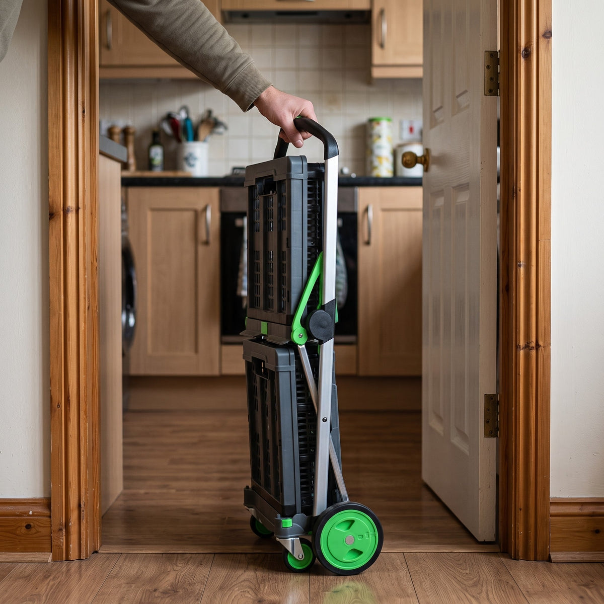 Step 3 - Fold: the EasyRoll trolley folded flat and held by one hand